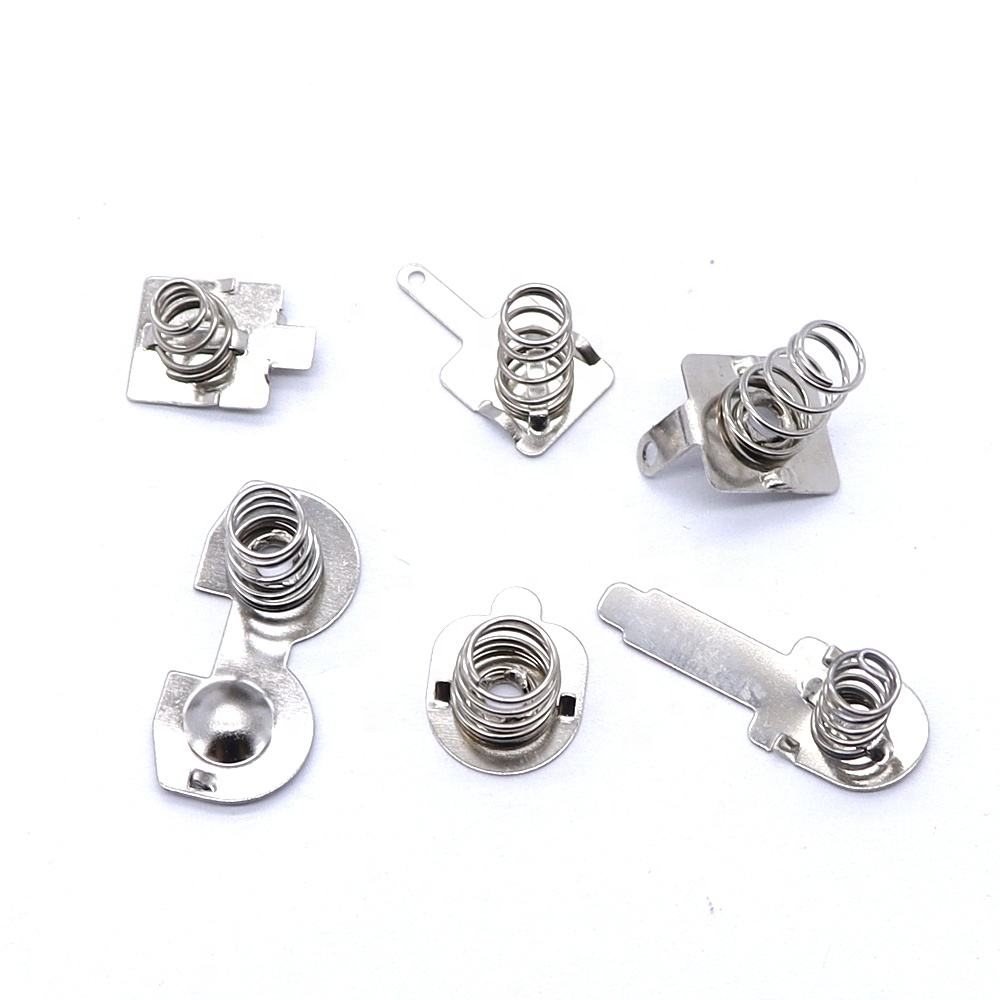 Stamped battery contact spring clips with coil springs